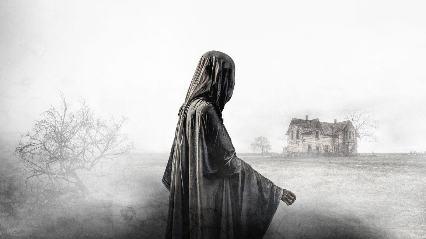 Poster for The Legend of La Llorona showing a ghostly figure walking across a misty hill with a house in the background