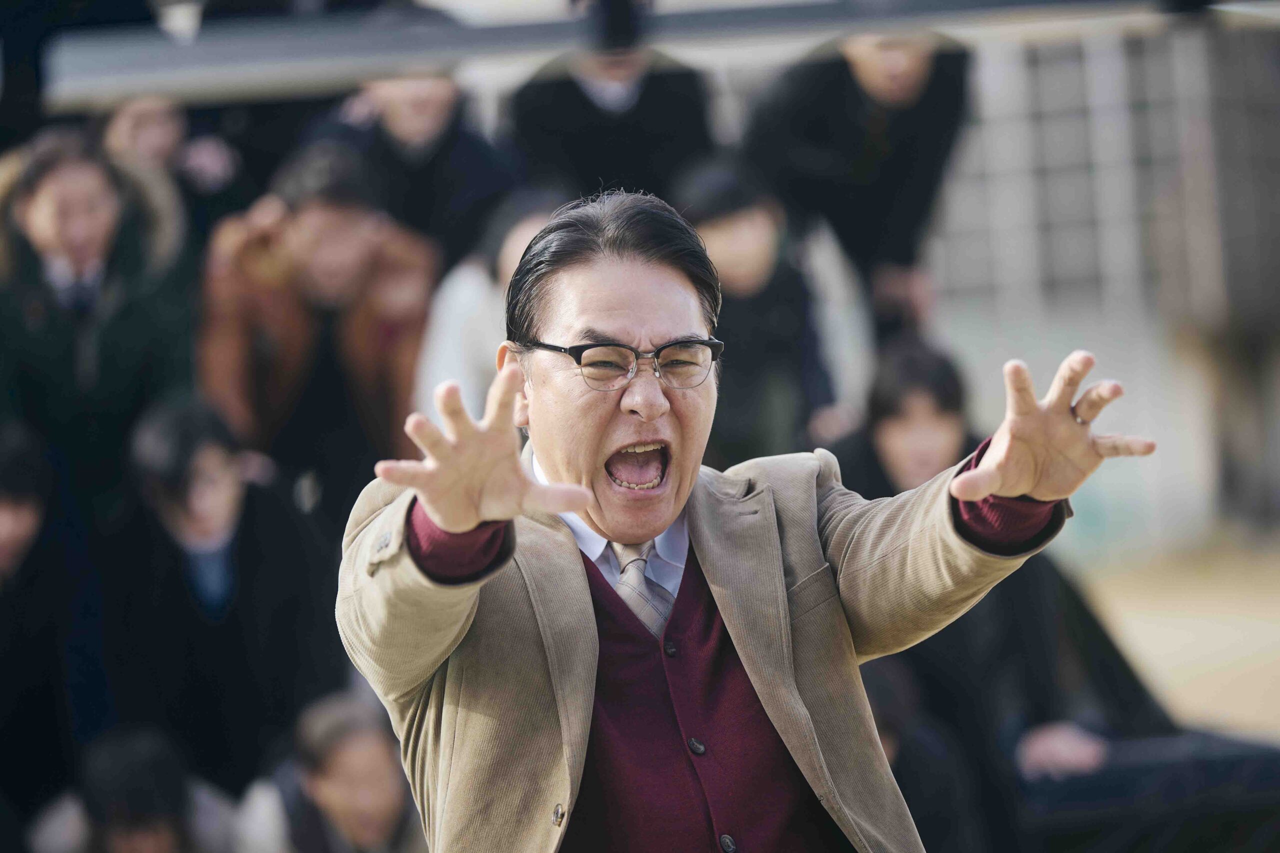 The school's principal in from of the Human Pyramid in New Group (2025)
